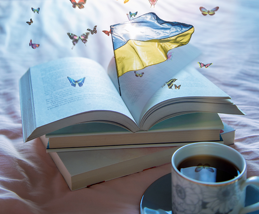 En öppen bok, i mitten syns Ukrainas flagga och runtom fjärilar